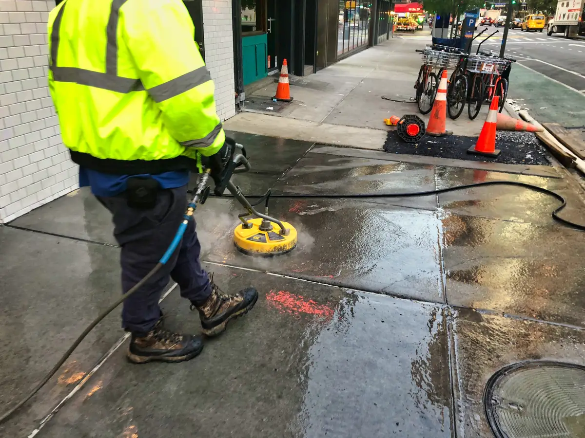 Clean apartment sidewalk in NYC after professional power washing service, showing safe and attractive walkways for residents and visitors